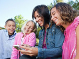 Family using a cell phone together