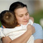 Mother hugging small child